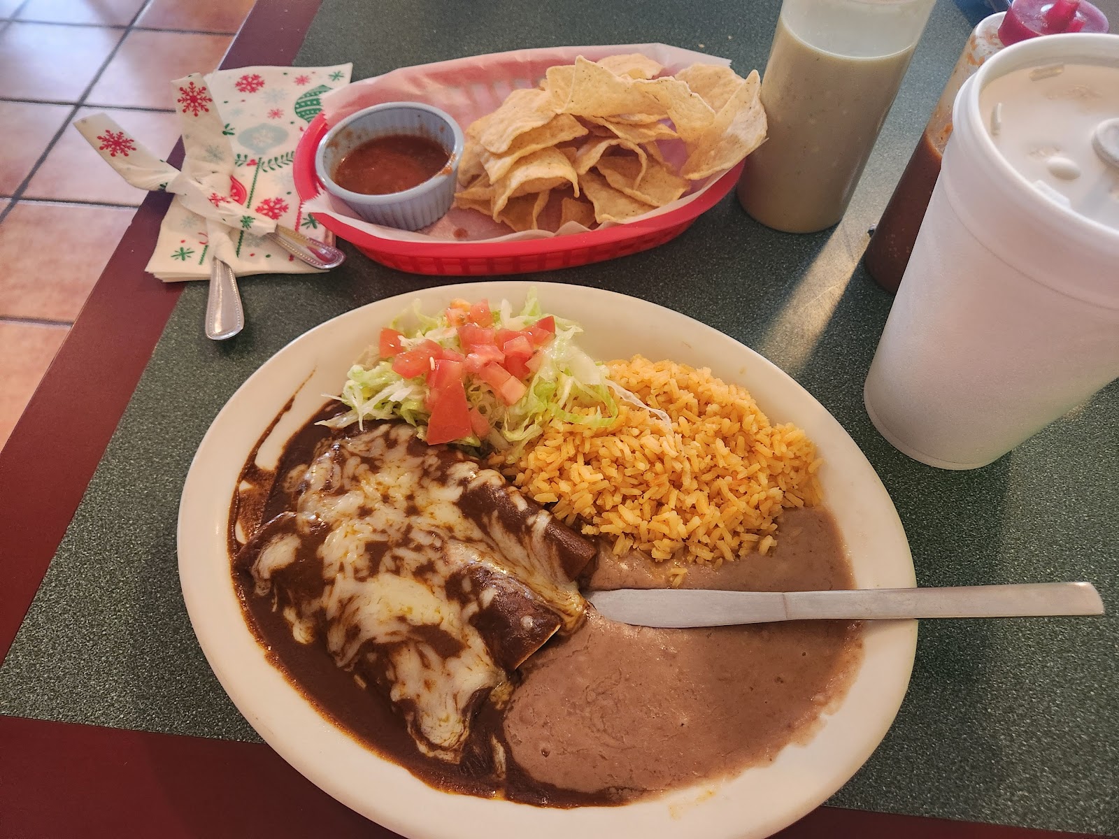 Enchilada plate with rice, beans, and chips at Mí Pueblito Mexican Restaurant