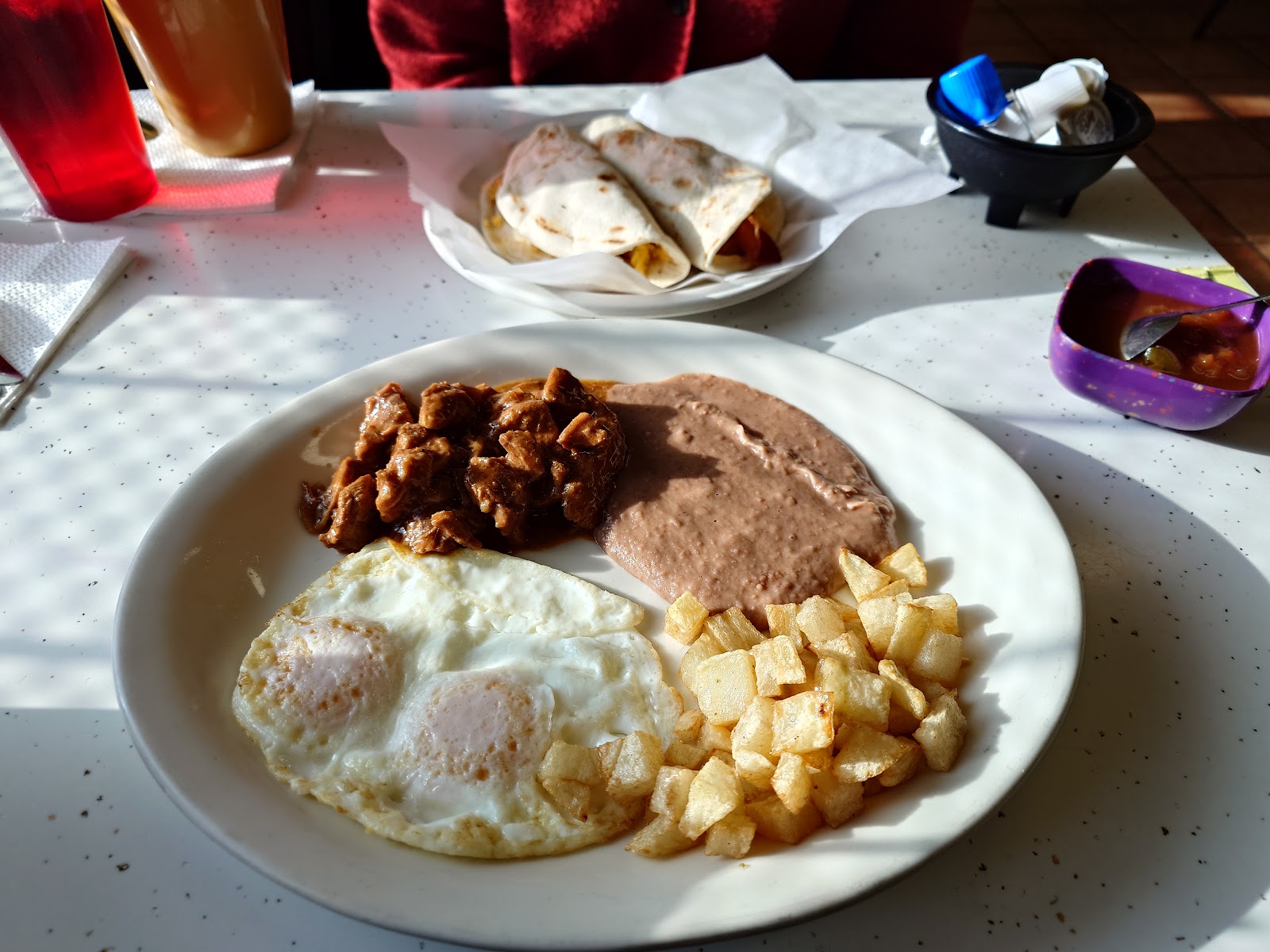 Breakfast plate with eggs, potatoes, beans and tortillas at Mí Pueblito Mexican Restaurant